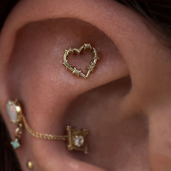 Barbed wire heart cartilage piercing earring by piercer @AdornedByAmelia 